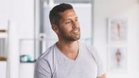 Male patient smiles in doctor's office